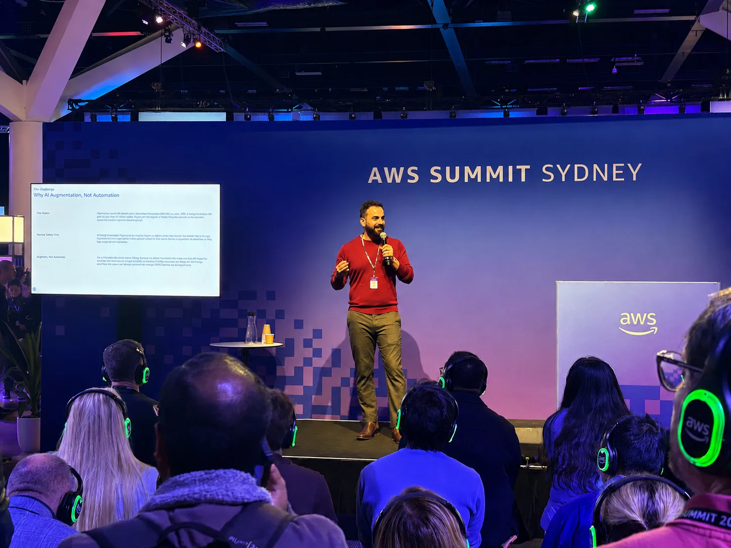Kanishka Mohaia presenting a human-in-the-loop AI Copilot talk at AWS Summit Sydney 2026.