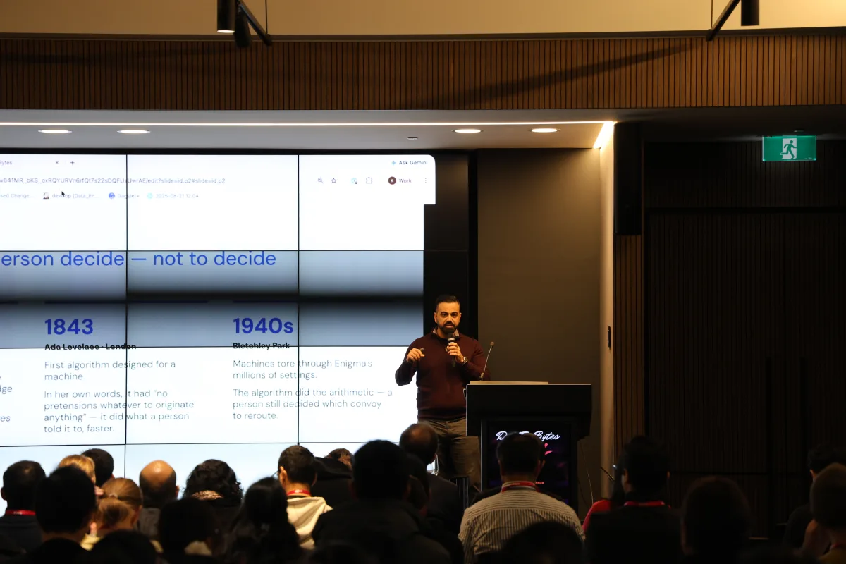 Kanishka Mohaia delivering the DataEngBytes 2026 keynote on stage in Sydney.